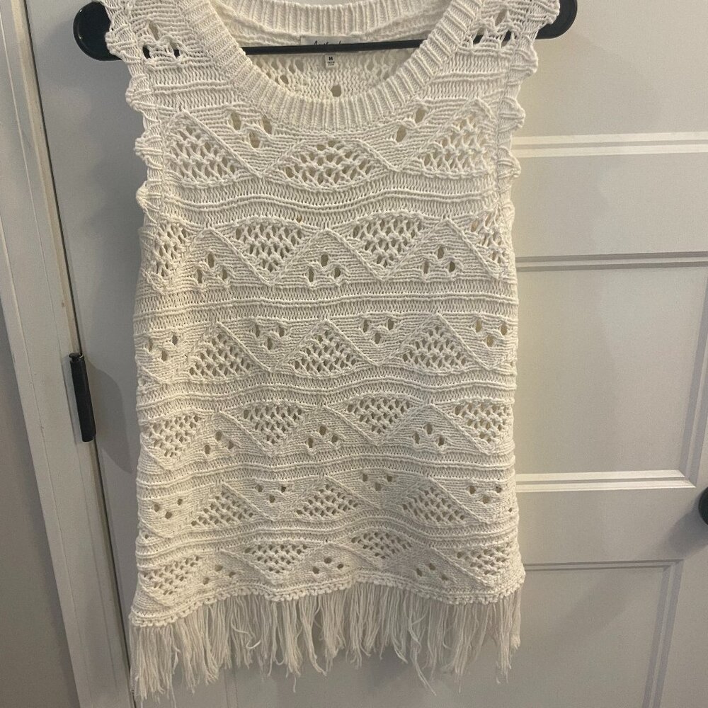 Another Love crochet sleeveless top with fringe at the bottom.